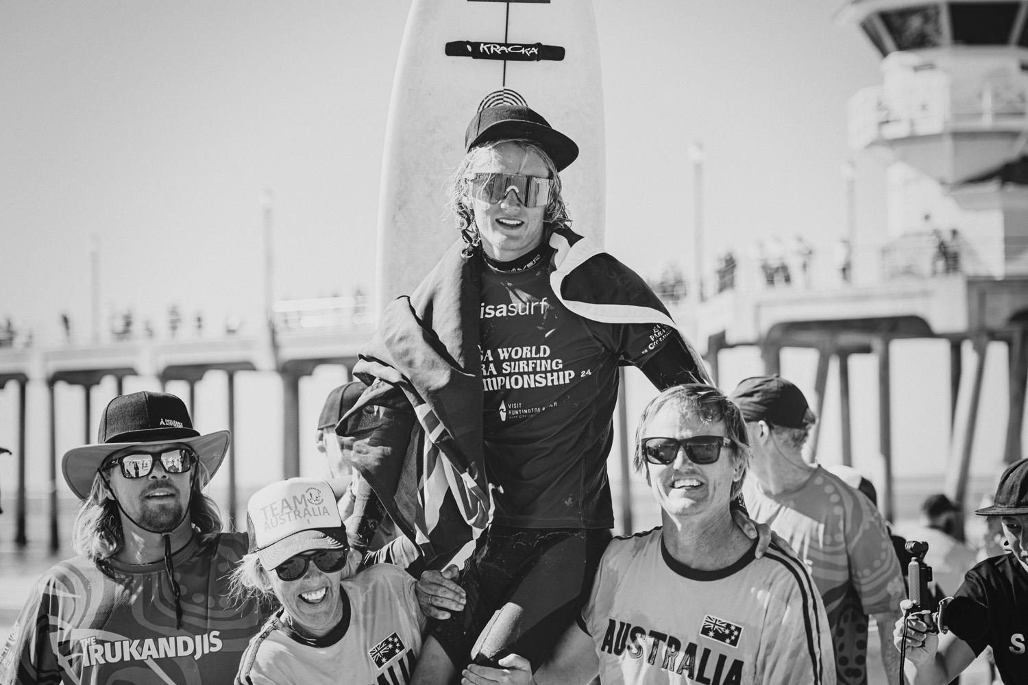 Kai Colless chaired off the beach by the Australian Irukandjis team after his ISA World Para Surfing Championship performance