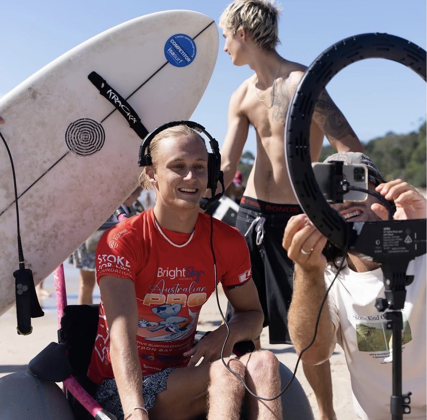 Kai Colless being interviewed with a headset at a surf event