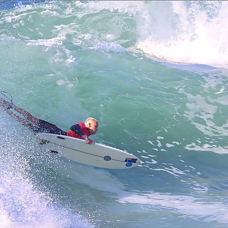Kai paddling out through whitewater