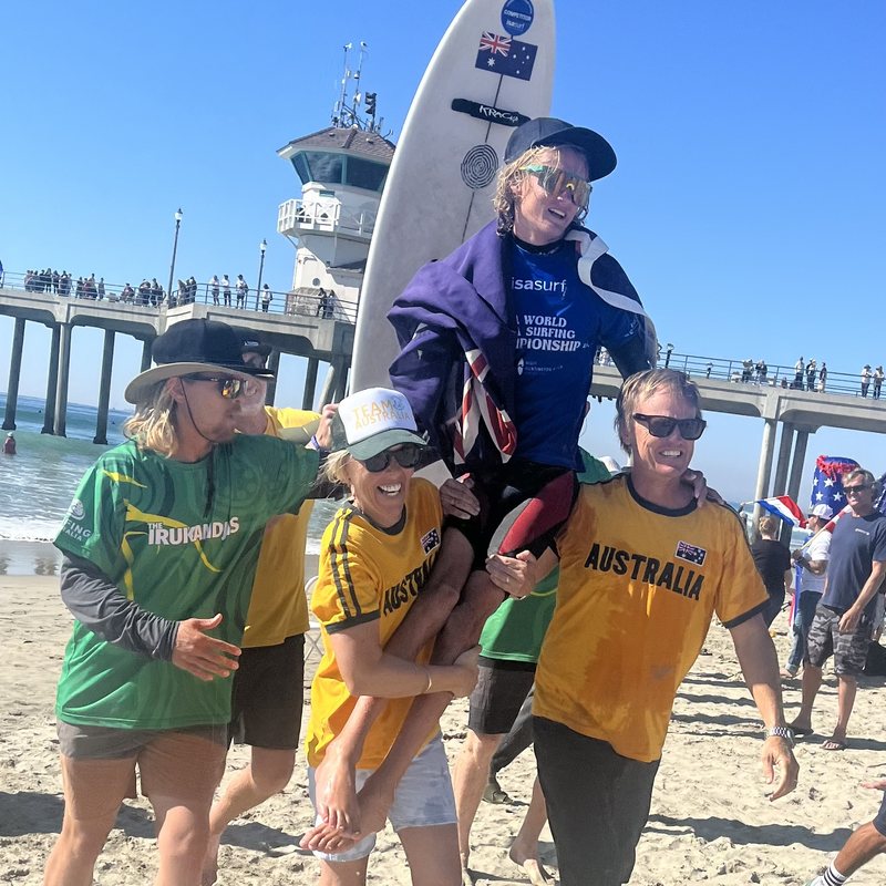 Kai being chaired up the beach by Team Australia after winning the ISA World Para Surfing Championship