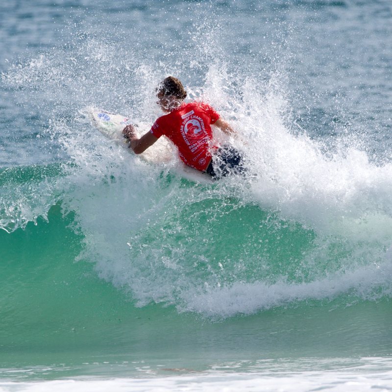 Kai cutting back hard on a wave at the Australian Para Surf Championships